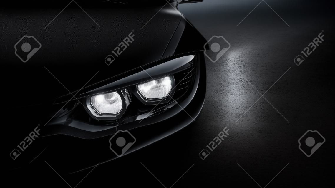 koplampen van zwarte sportwagen op zwart