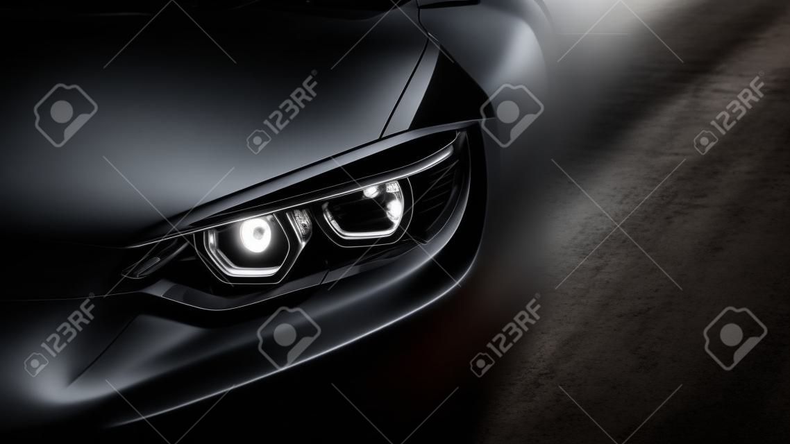 headlights of black sports car on black