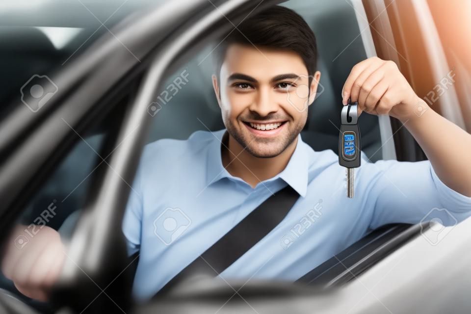 Man showing car key