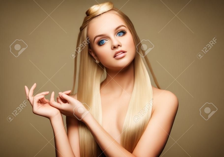 Torso portrait of the beautiful blonde young  woman with pigtails and natural make up posing with her arms