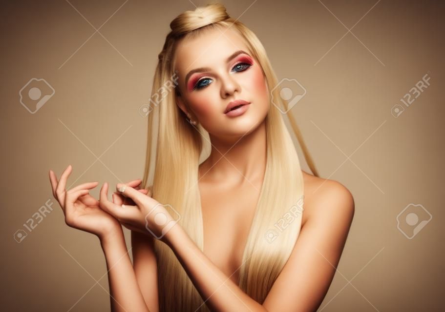 Torso portrait of the beautiful blonde young  woman with pigtails and natural make up posing with her arms