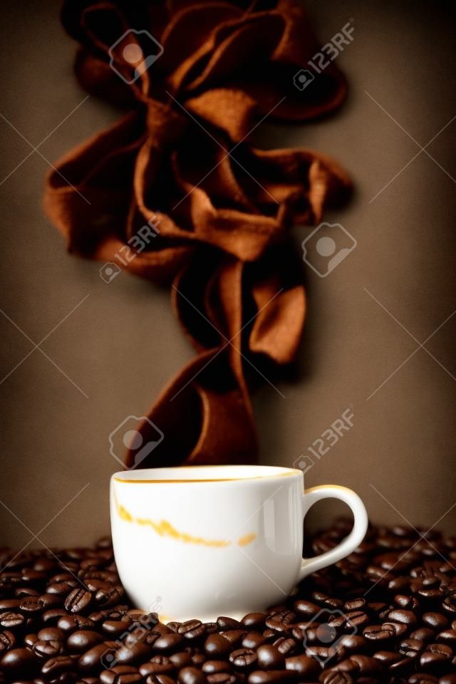 still life of the warm black cup of coffee on  roasted coffee beans
