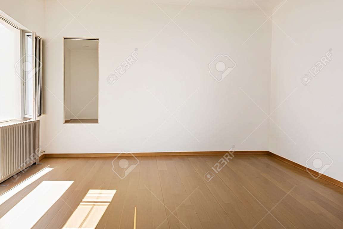 Empty room with parquet and white walls. Nobody inside