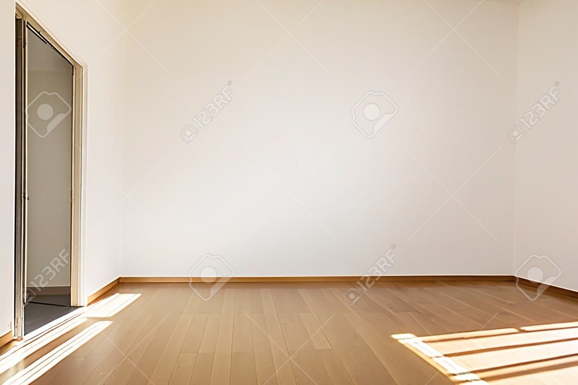 Empty room with parquet and white walls. Nobody inside