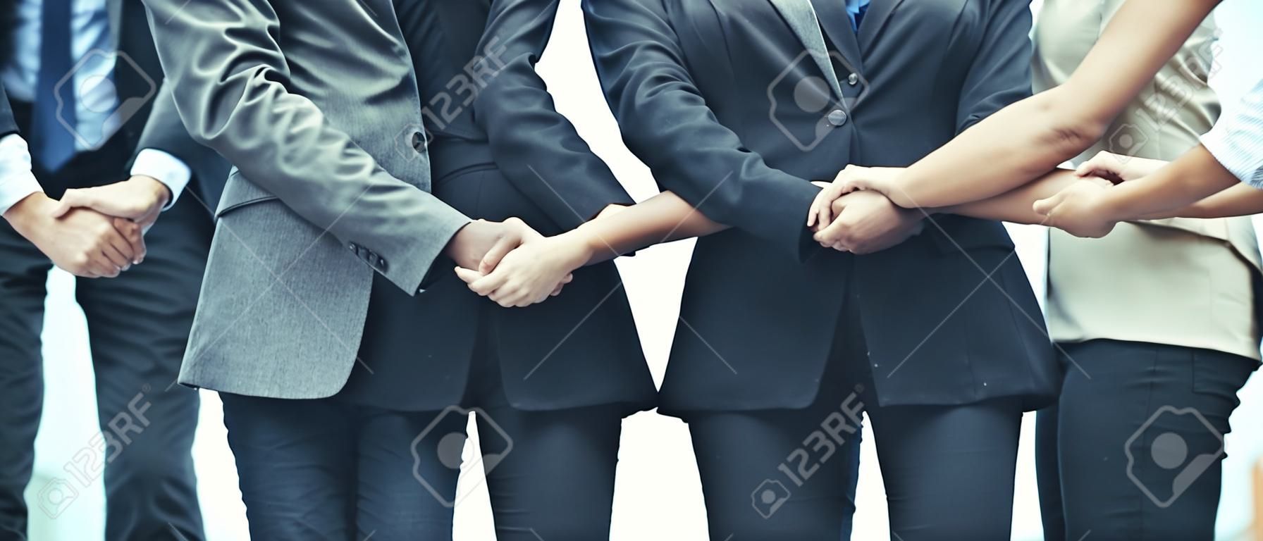 Business people holding hands together showing teamwork, people unity, corporate for businesses success.