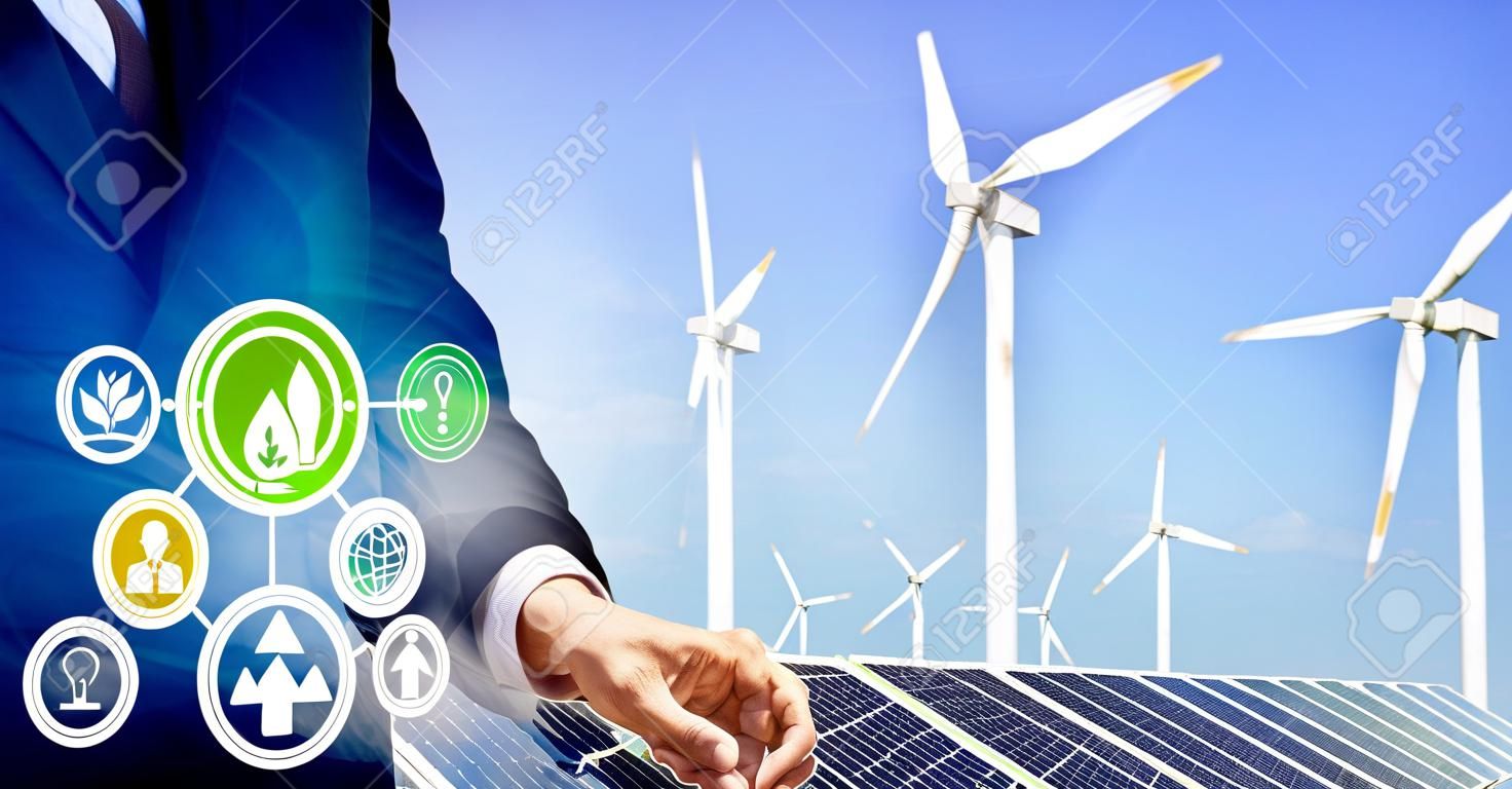Grafika z podwójną ekspozycją przedstawiającą ludzi biznesu pracujących nad farmą turbin wiatrowych i koncepcję interfejsu pracownika zielonej energii odnawialnej w zakresie zrównoważonego rozwoju poprzez energię alternatywną