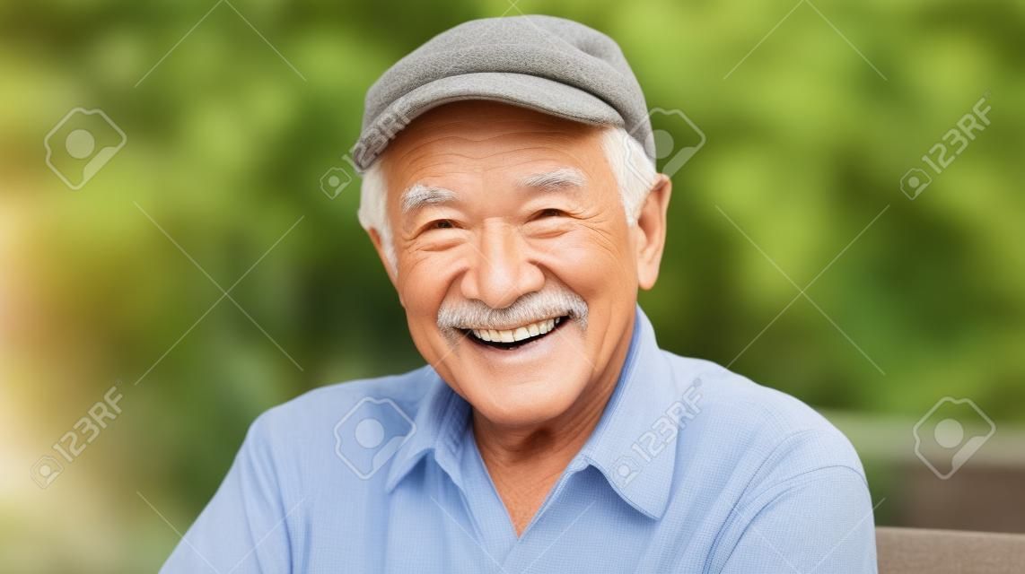 Smiling senior man sitting in the garden looking at the camera smiling. Generative AI AIG20.