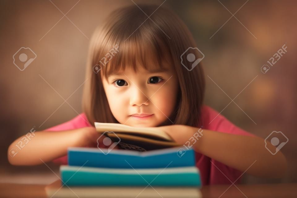 A little girl reading the book