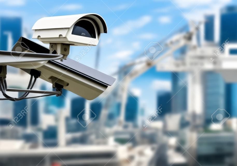 security CCTV camera or surveillance system with construction site on blurry background