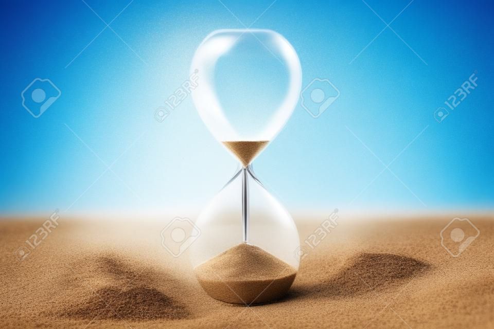 Time is running out concept. An hourglass with sand falling through, on a vibrant blue background with a place for text