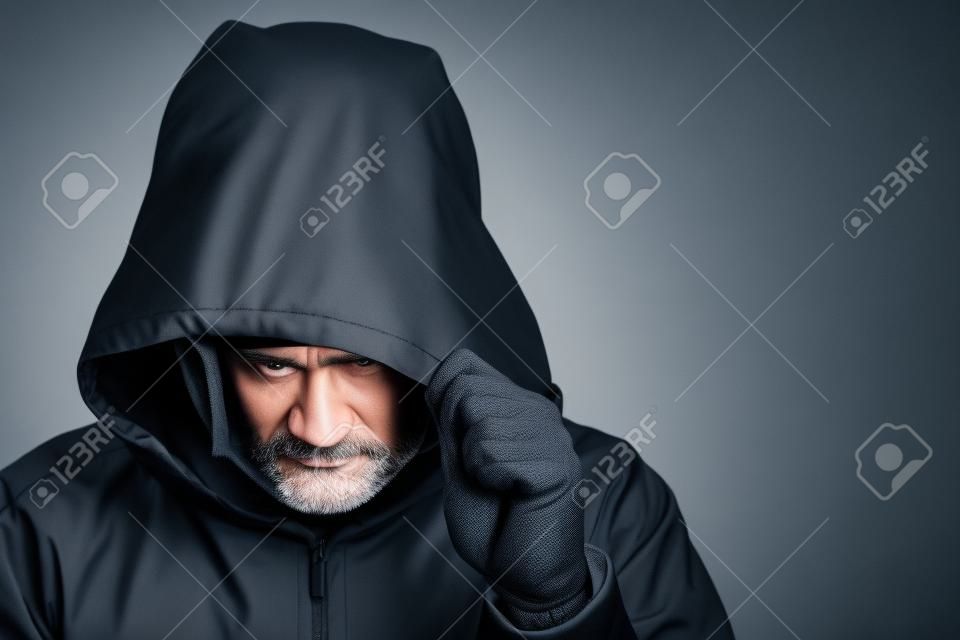 Suspicious man wearing a hood and mask