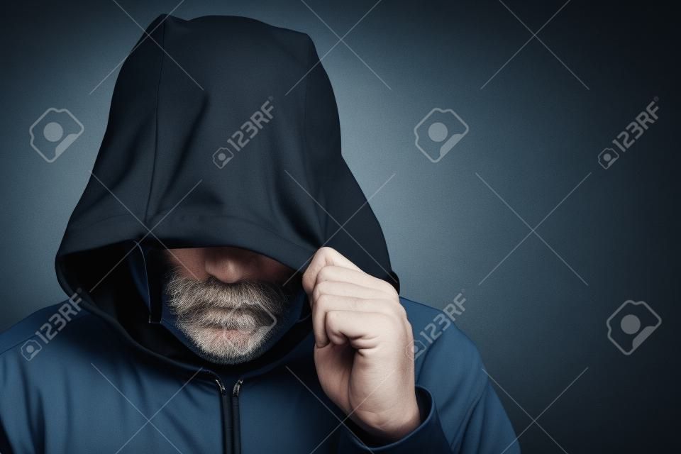 Suspicious man wearing a hood and mask