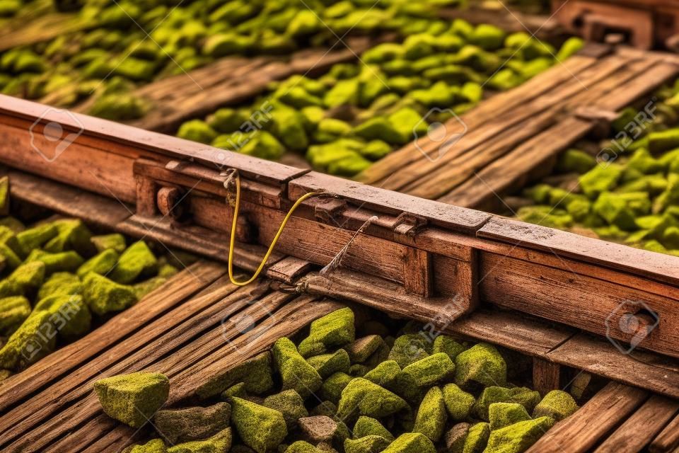 Close up of old connecting point train or railroad tracks with wooden backing In the countryside Thailand