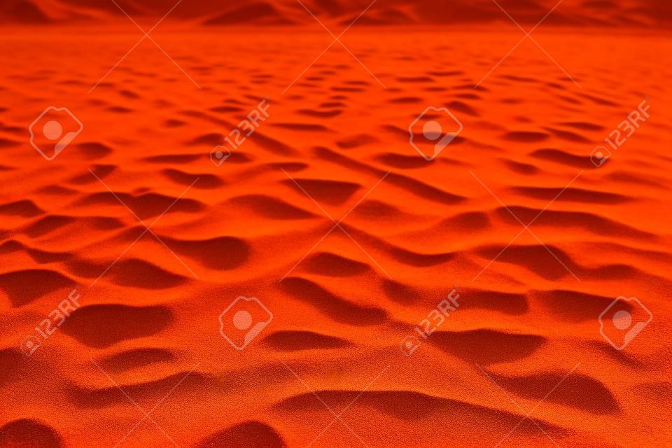 Zand textuur achtergrond. Bruine woestijn patroon van tropisch strand. Close-up.