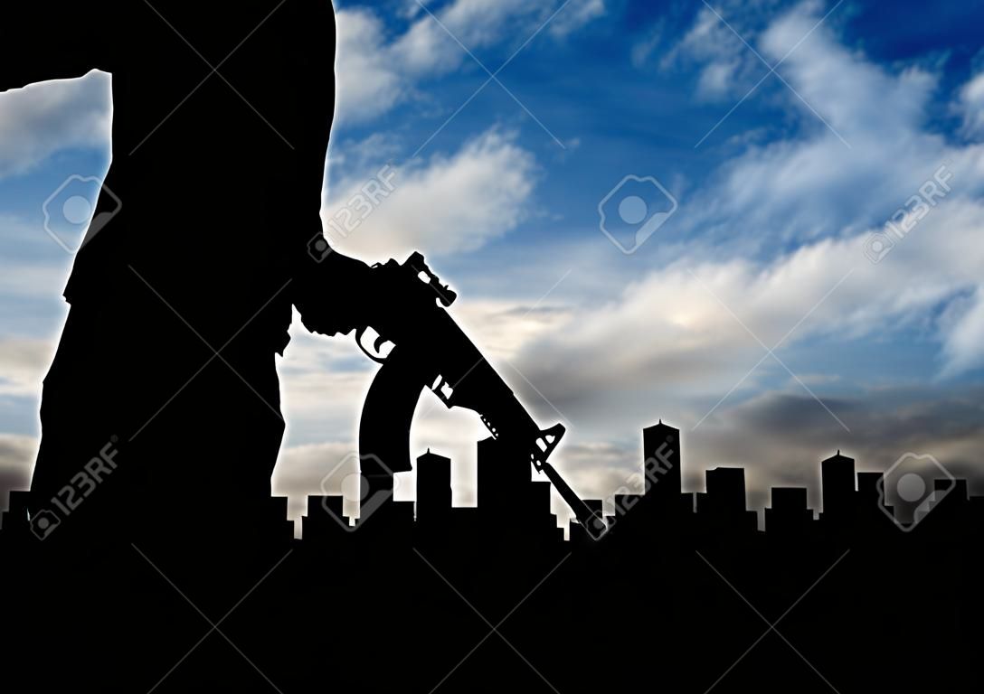 Terrorist concept. Silhouette terrorists, against the background of the urban landscape in smoke