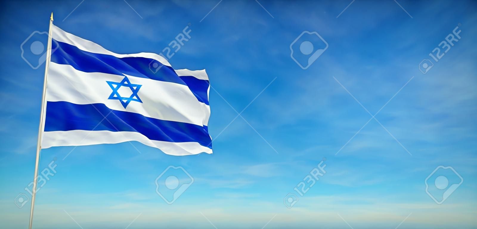 The National flag of Israel blowing in the wind in front of a clear blue sky
