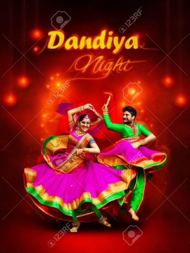 Indian couple playing Garba in Dandiya Night Navratri Dussehra festival of India