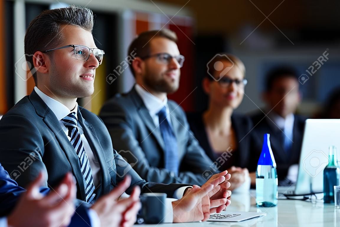 Modern managers listening to speaker at conference or seminar