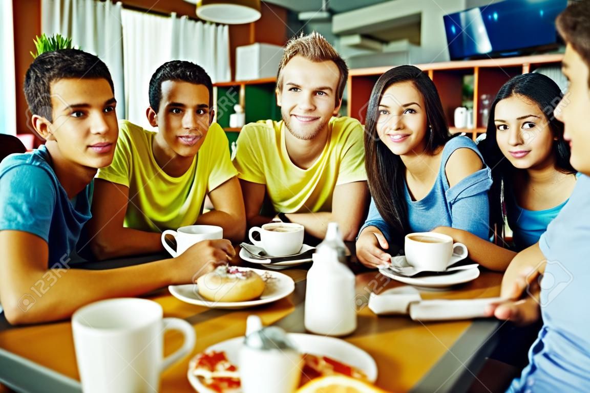Portrait of teenage friends meeting in cafe