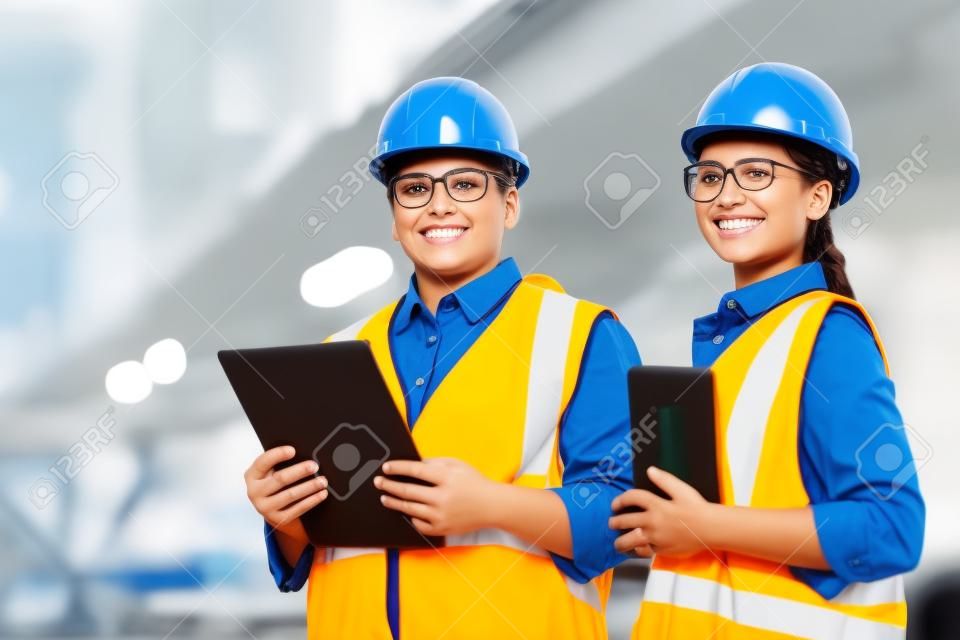 Group of happy workers in uniform looking at camera