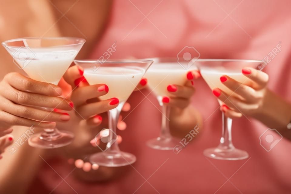 Mani femminili con cocktail durante il brindisi