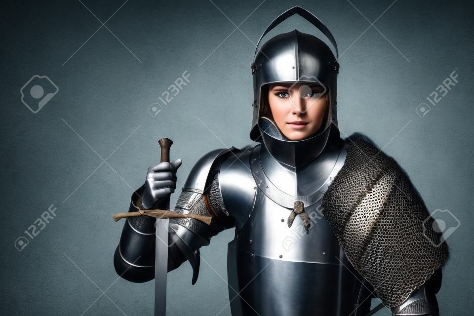 Portrait of a medieval female knight in armour over grey background.