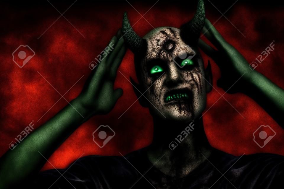 A portrait of a bad demon over the grunge background. Horror movie, nightmare. Halloween.
