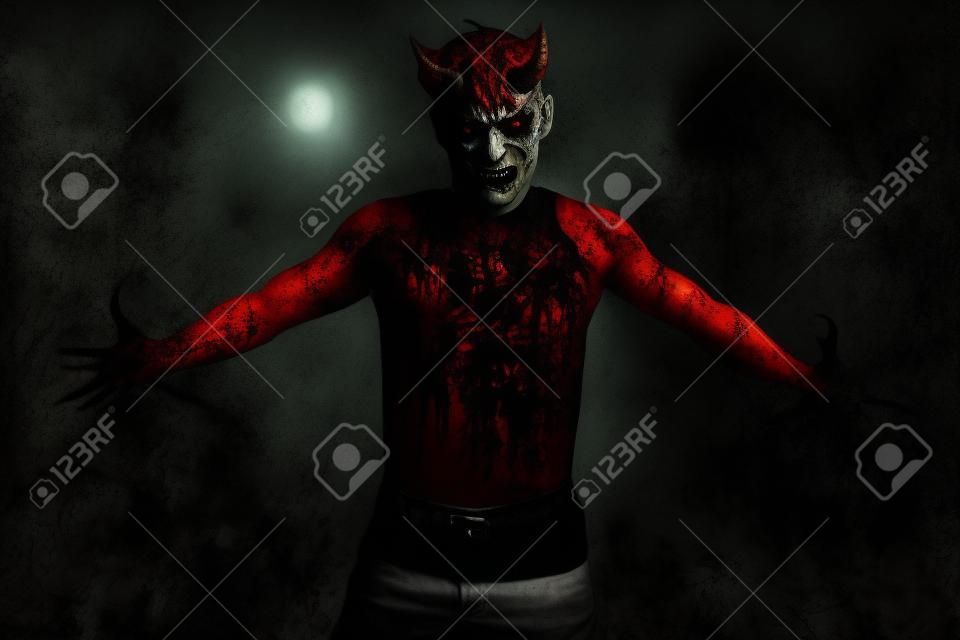 A portrait of a bad demon over the grunge background. Horror movie, nightmare. Halloween.