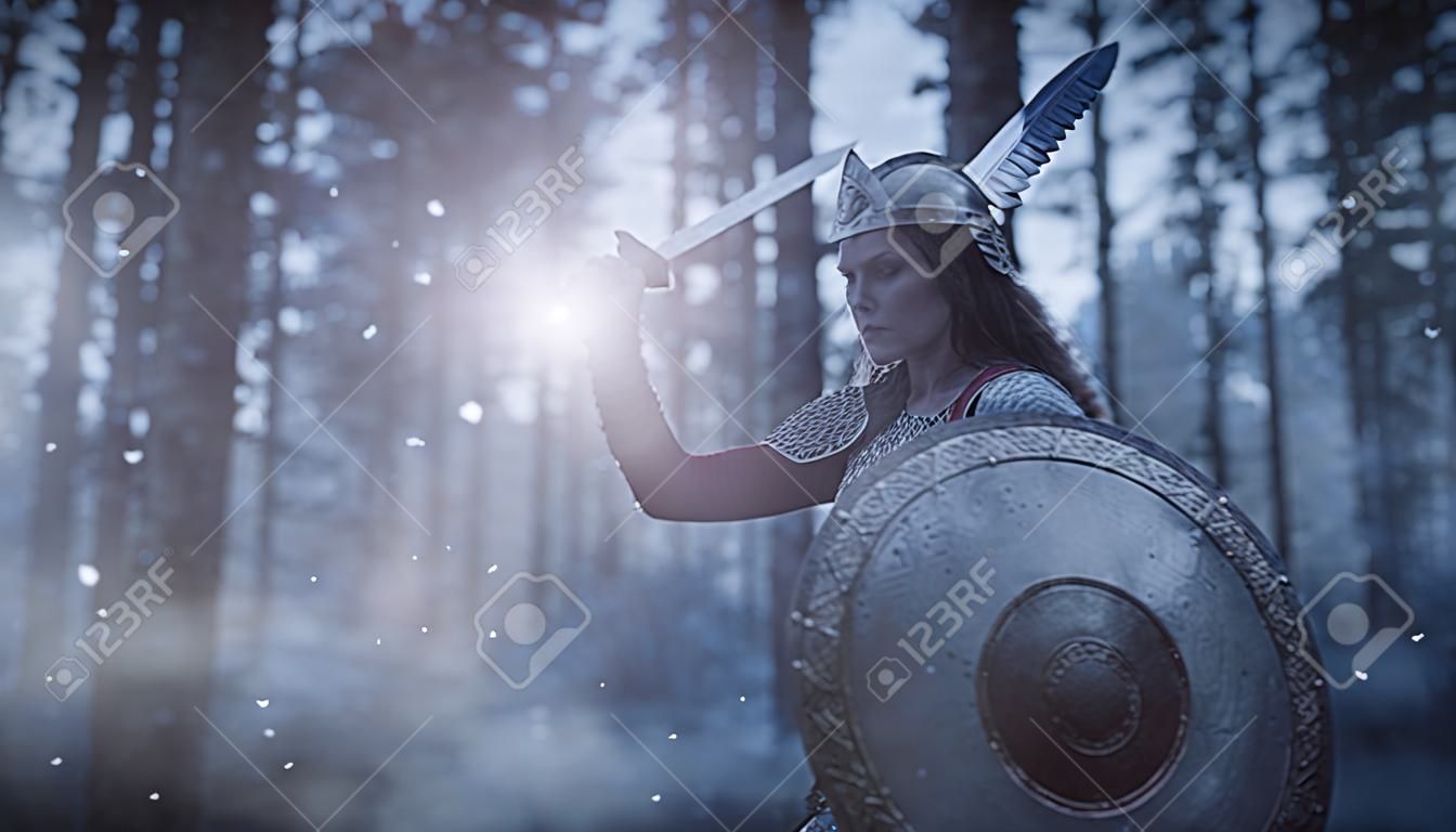 Epic fantasy. Divine female warrior valkyrie fights with a sword and shield in her hands on the battlefield during darkness. Scandinavian mythology.