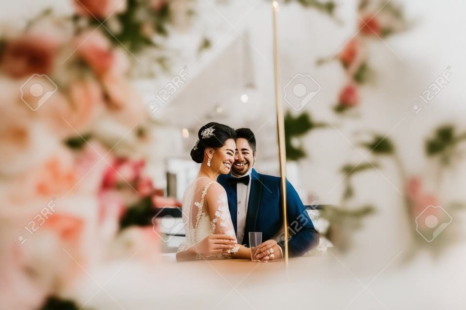 a wonderful couple celebrating in a cafe on her wedding day