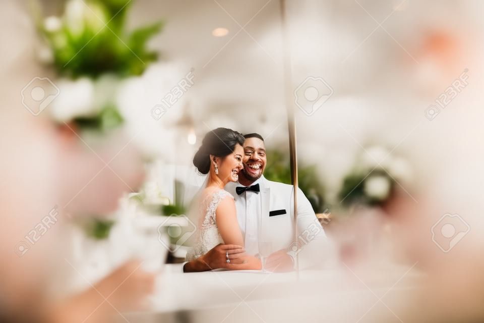 a wonderful couple celebrating in a cafe on her wedding day