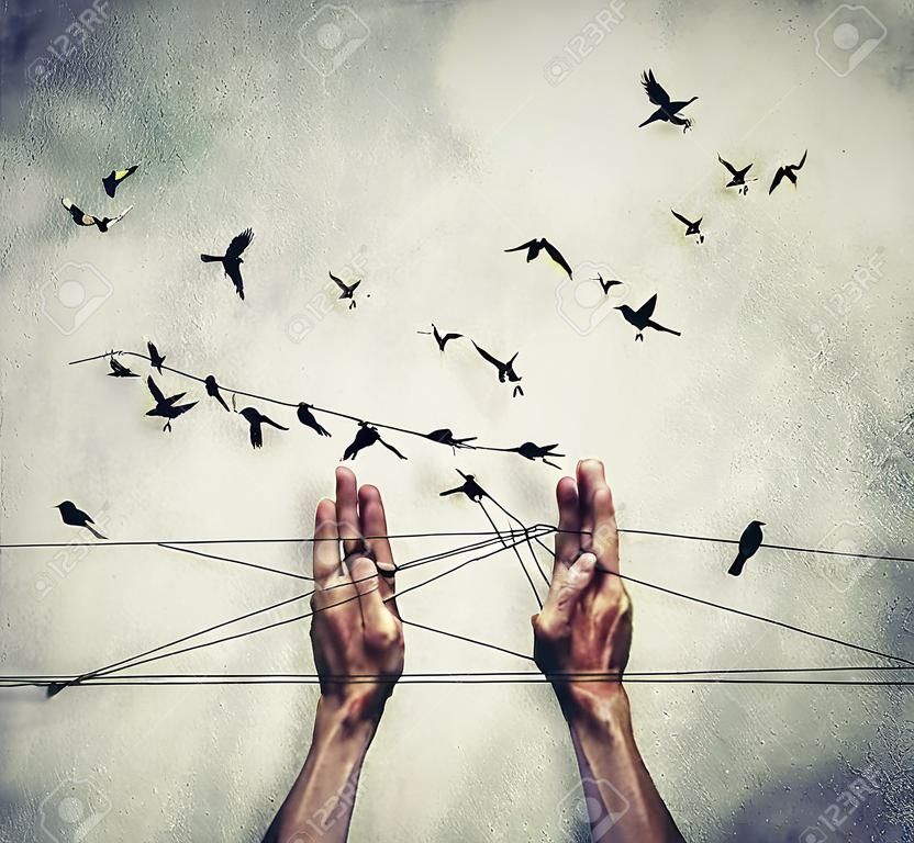 Man hands tied with thread playing cats cradle game with birds standing like on a wire and flying around. Trying to lure birds. Some birds are not meant to be caged