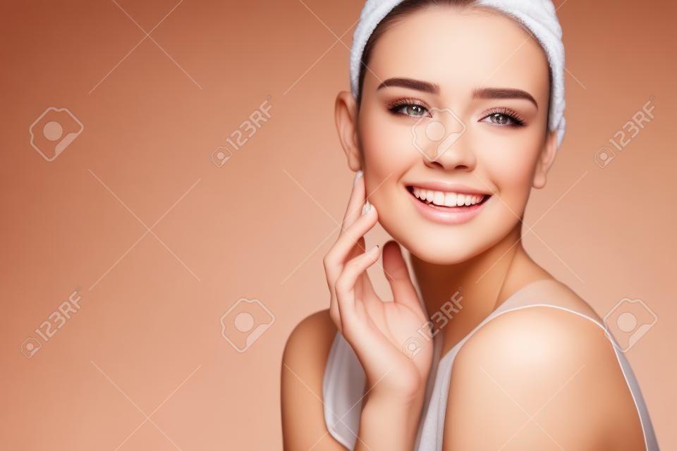 Beauty Cosmetics. Portrait Of Beautiful Smiling Woman Caressing Perfect Soft Skin. Close Up Of Attractive Young Female Model With Professional Natural Makeup. Facial Care. High Resolution