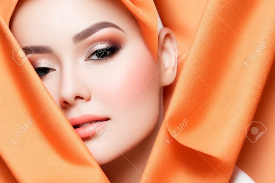 Face Skin Beauty. Beautiful Woman With Natural Makeup, Healthy Skin With White Pieces Of Fabric. High Resolution.