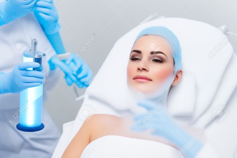Cosmetology. Woman At Facial Oxygen Cryotherapy At Beauty Centre. Cryo Treatment On Face. High Resolution