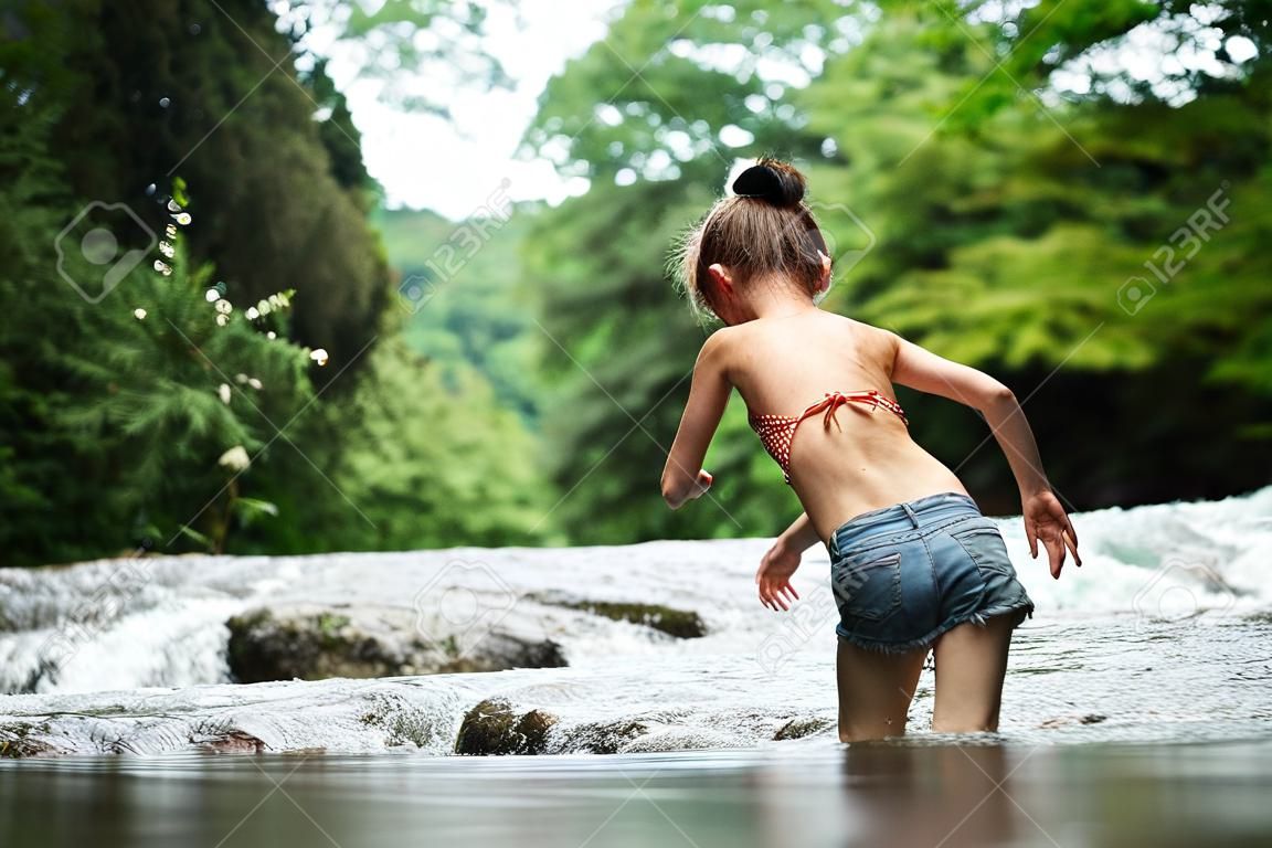 Girl playing in the river