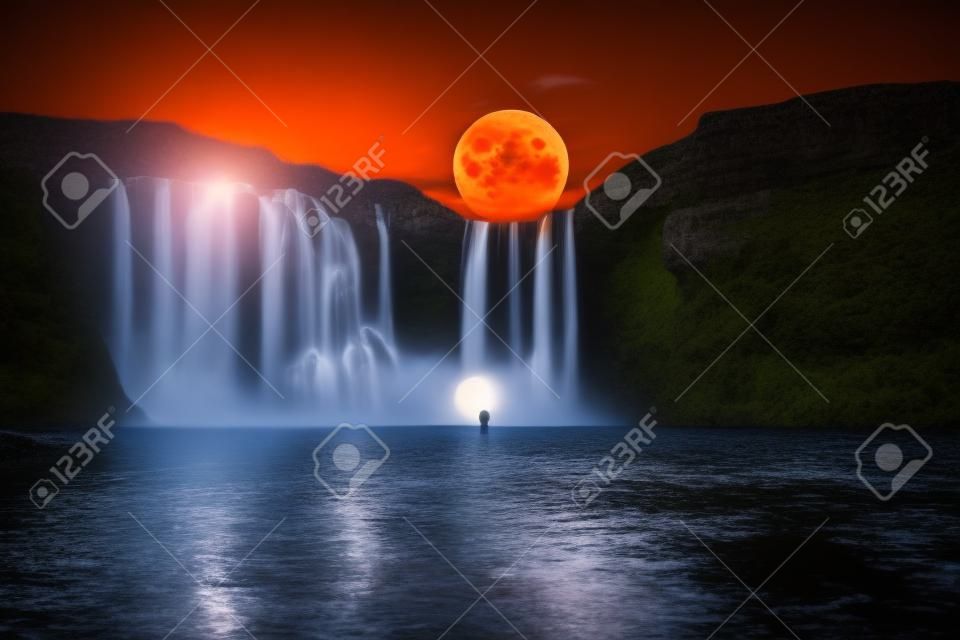 Orange moon over great waterfall