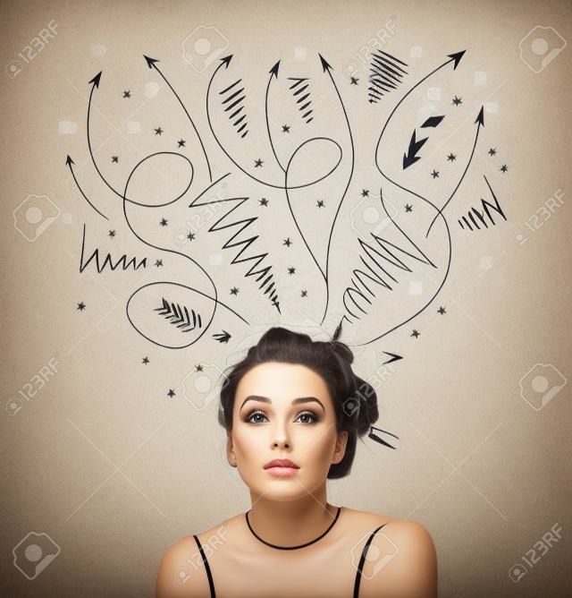 Pretty young woman deciding with sketched arrows over her head
