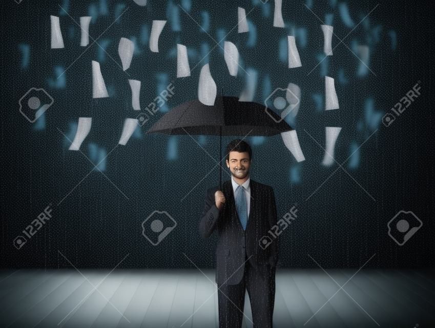 Businessman standing with umbrella in dollar bill rain concept on background