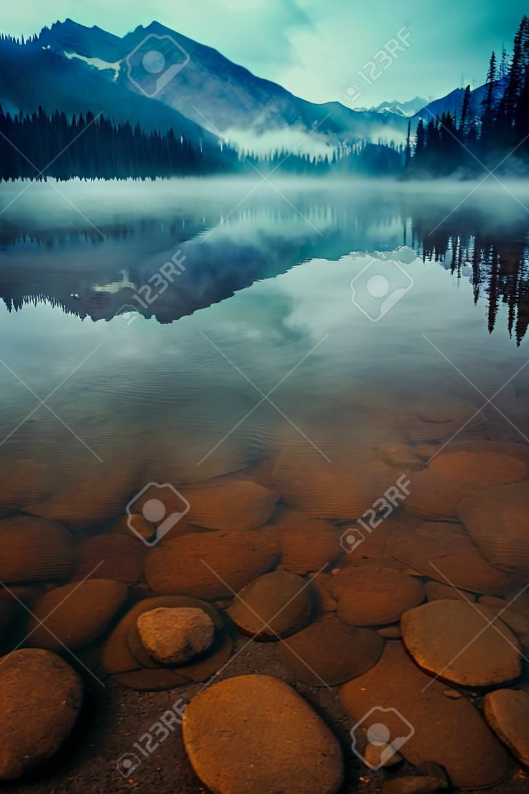 Lake Herbert in a foggy morning with glaciers mountain and reflection in Banff National Park, Canada