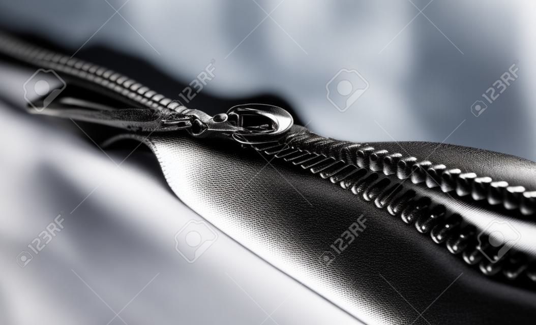 black metal open zipper closeup isolated on white background macro