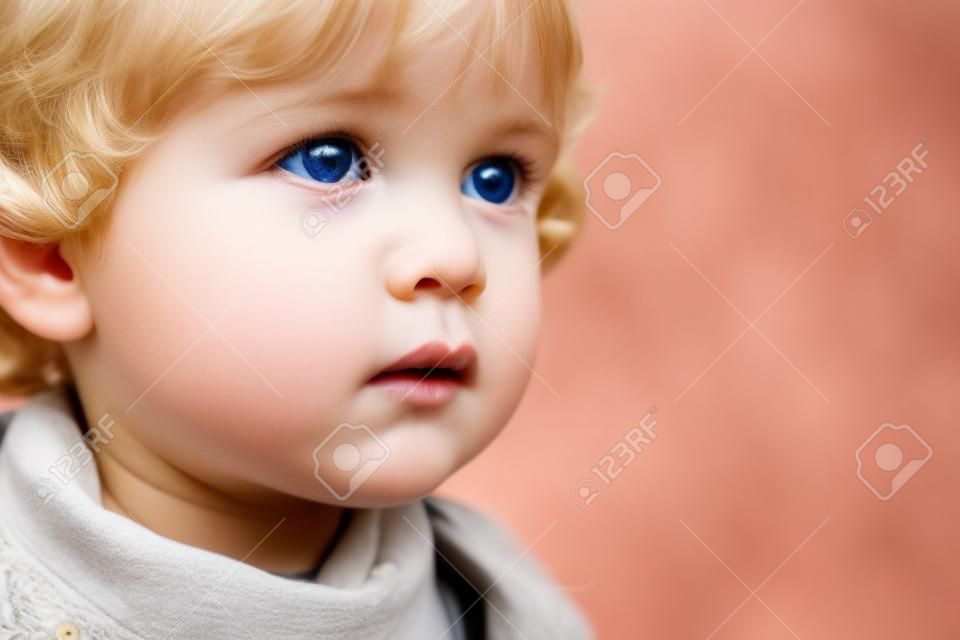 Close-up of a lovely child with pretty eyes and blonde hair