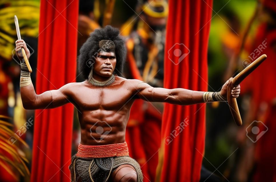 Portrait of one Yugambeh Aboriginal warrior man preform Aboriginal culture martial art during cultural  show in Queensland, Australia.