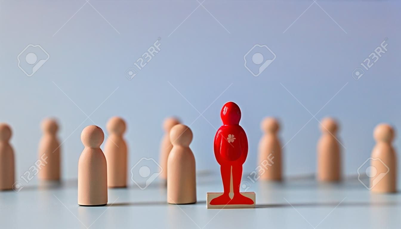 Business hiring and recruitment selection. Career opportunity. Human Resource Management. red human icon standing on a trophy of an employee leader from the crowd.