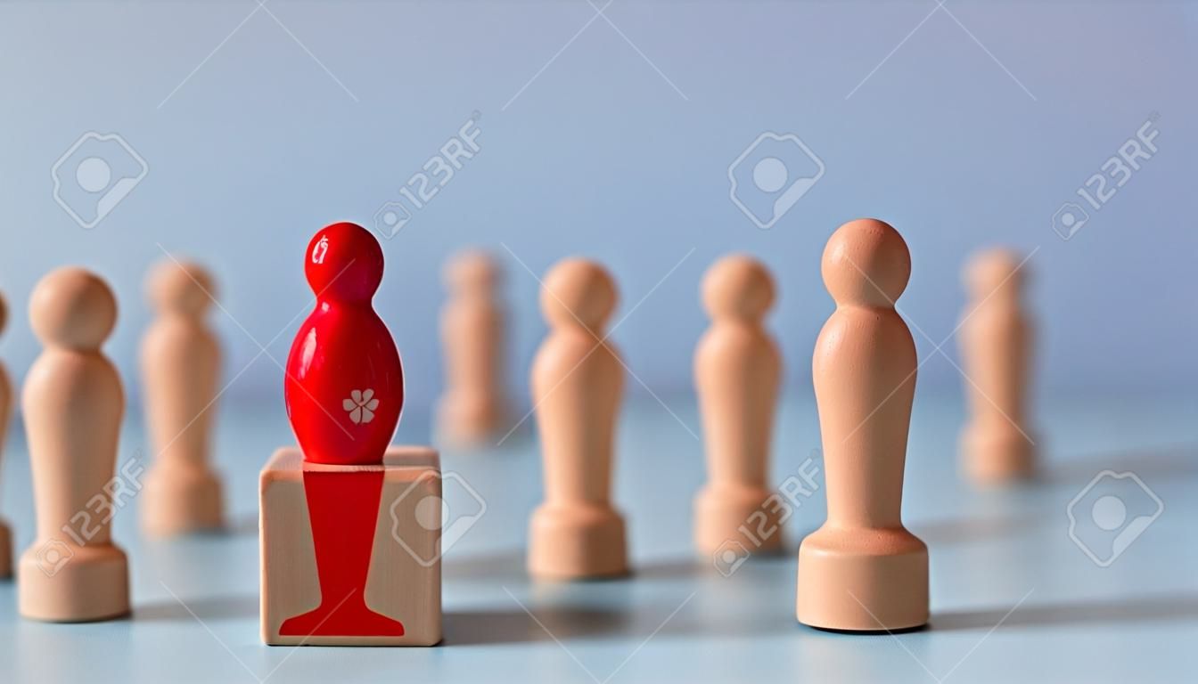 Business hiring and recruitment selection. Career opportunity. Human Resource Management. red human icon standing on a trophy of an employee leader from the crowd.
