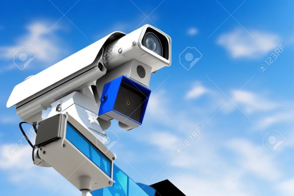 Isolated speed control camera with a radar, close-up, blue sky background, front view, free space for text.