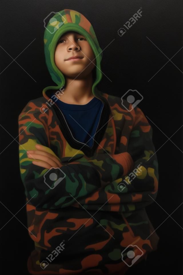 Portrait of a teenage boy on a black background