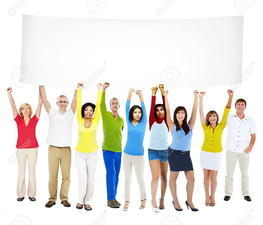 Multi-Ethnic Group Of Casual People With Their Arms Raised And Holding Empty Banner For A Copy Space.