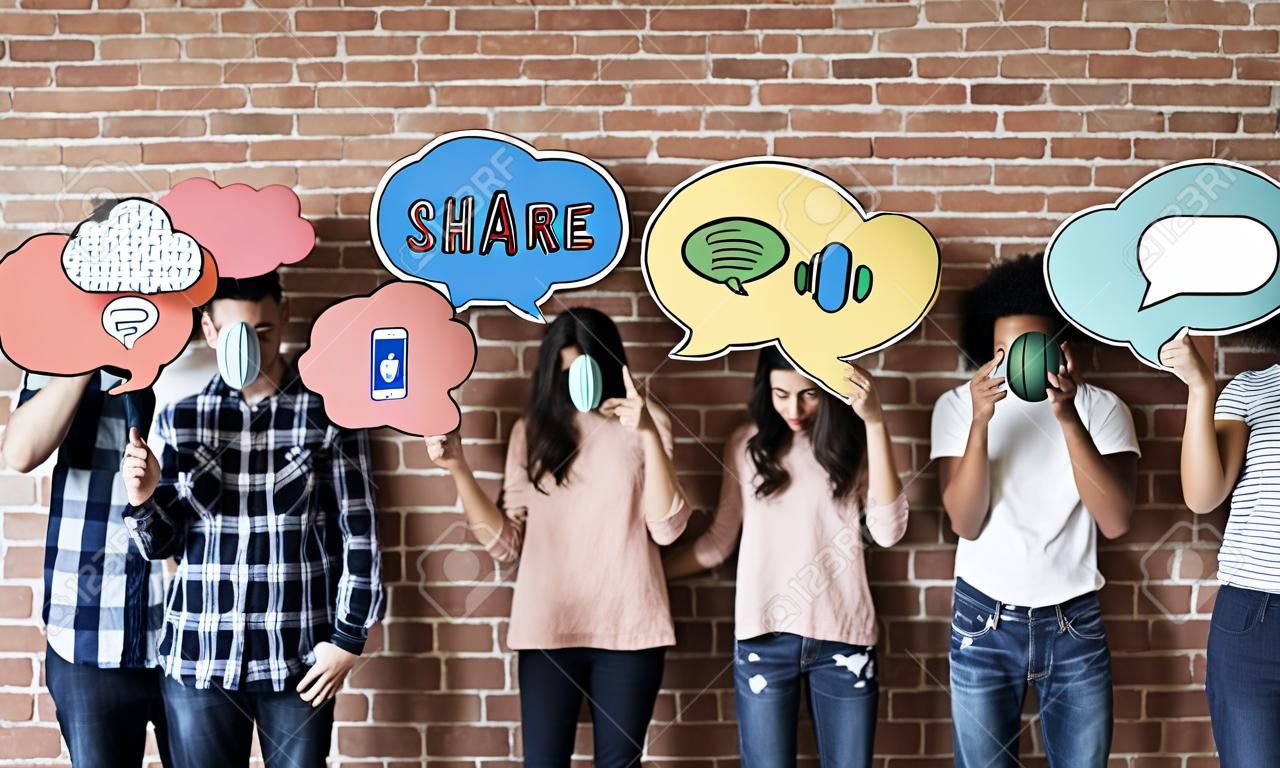 Friends holding up thought bubbles with social media concept icons
