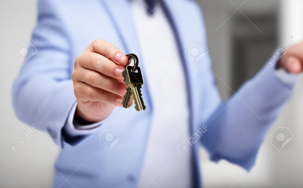 Real estate agent handing the house key